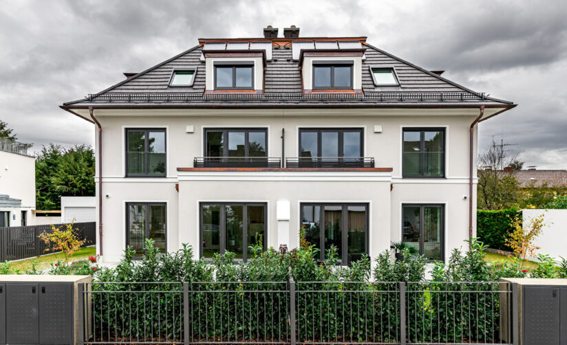Straßenansicht eines Neubau Doppelhauses im Villenstil in München Großhadern von DOMINO Bau