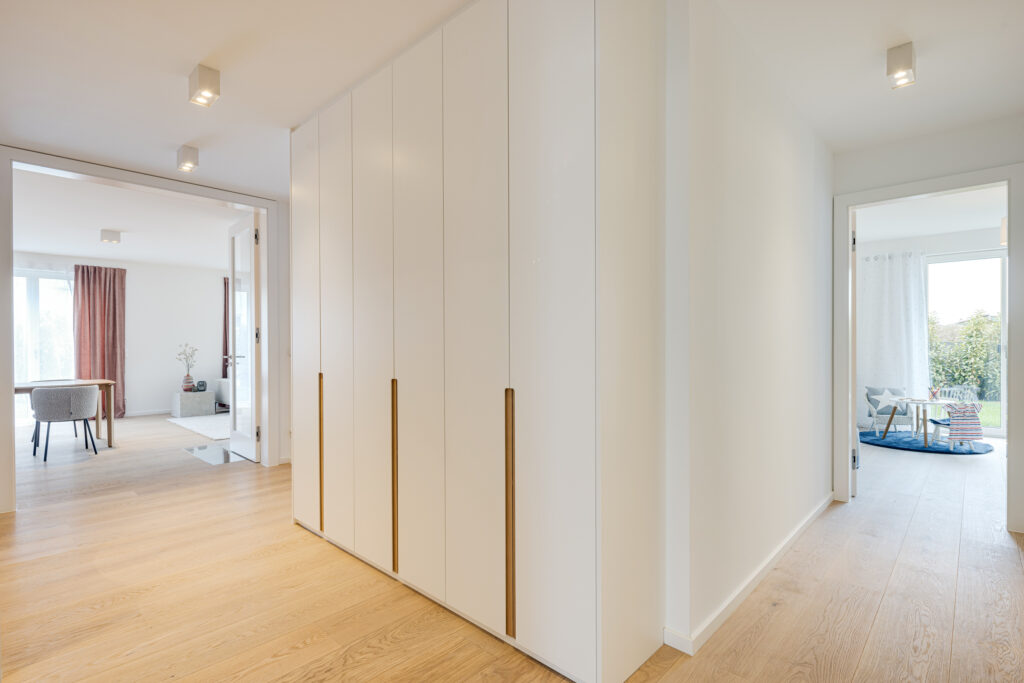 Foto eines Flurs mit Einbauschrank, Neubau Mehrfamilienhaus mit drei Wohnungen von DOMINO Bau in München Solln